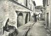 / CPSM FRANCE 34 "Saint Guilhem le Désert, vieille rue, la fontaine et l'ancienne chapelle des Pénitents"